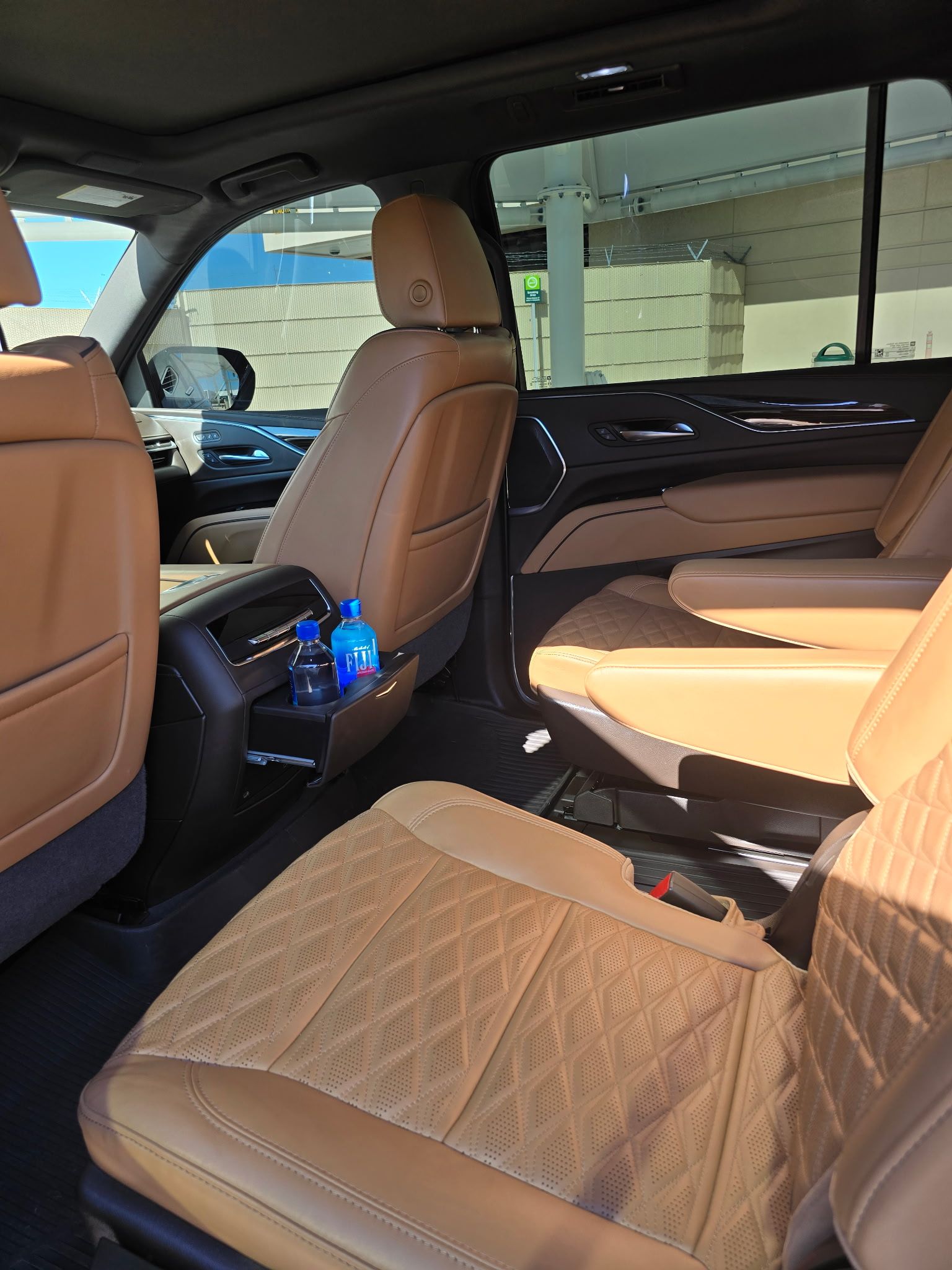 Spacious Cadillac Escalade second-row featuring diamond-stitched tan leather seats